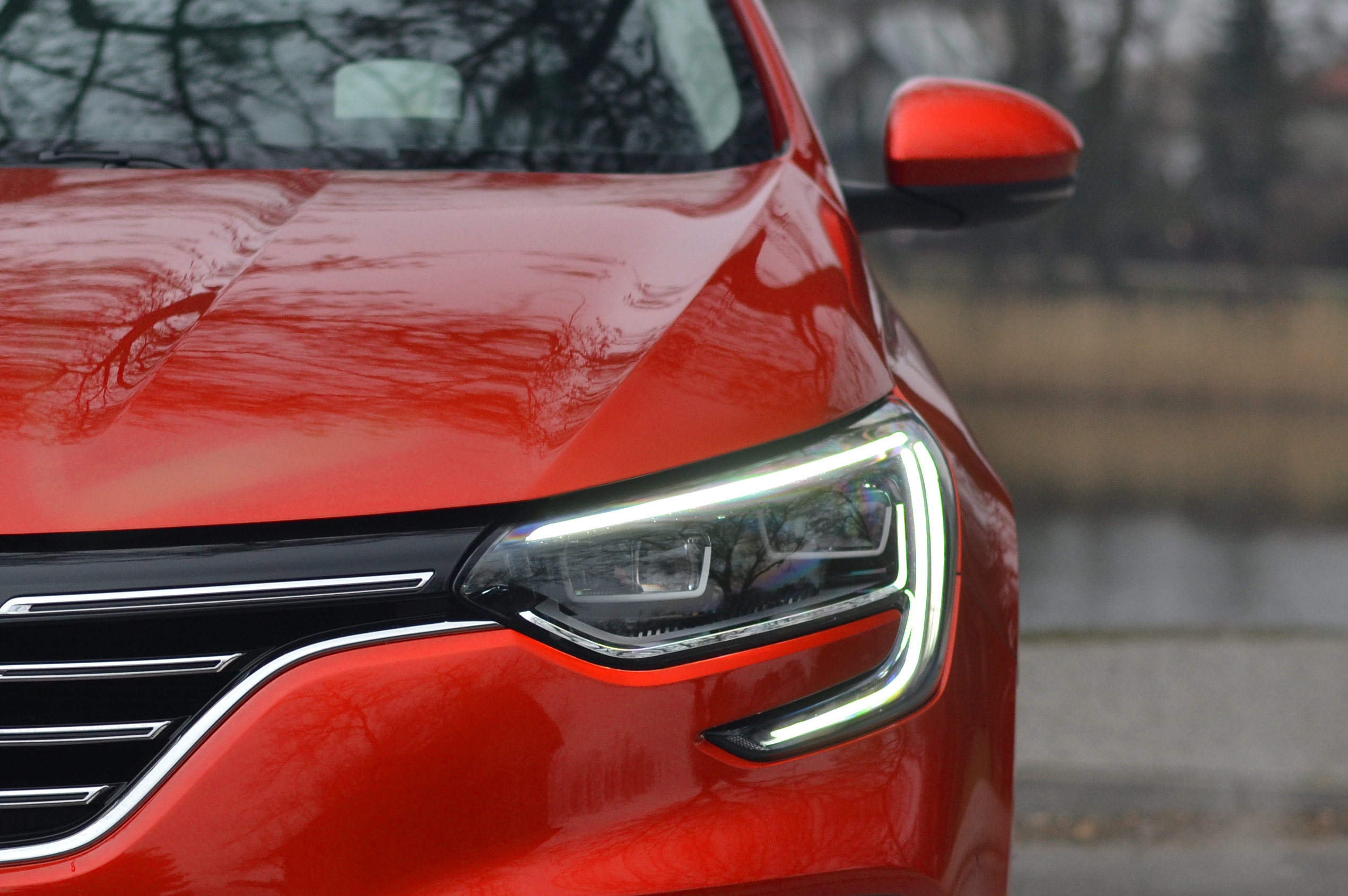 Close-up of the front of a red car.