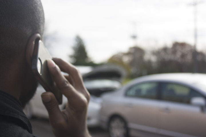 Over-the-shoulder photo of man talking on cellphone.