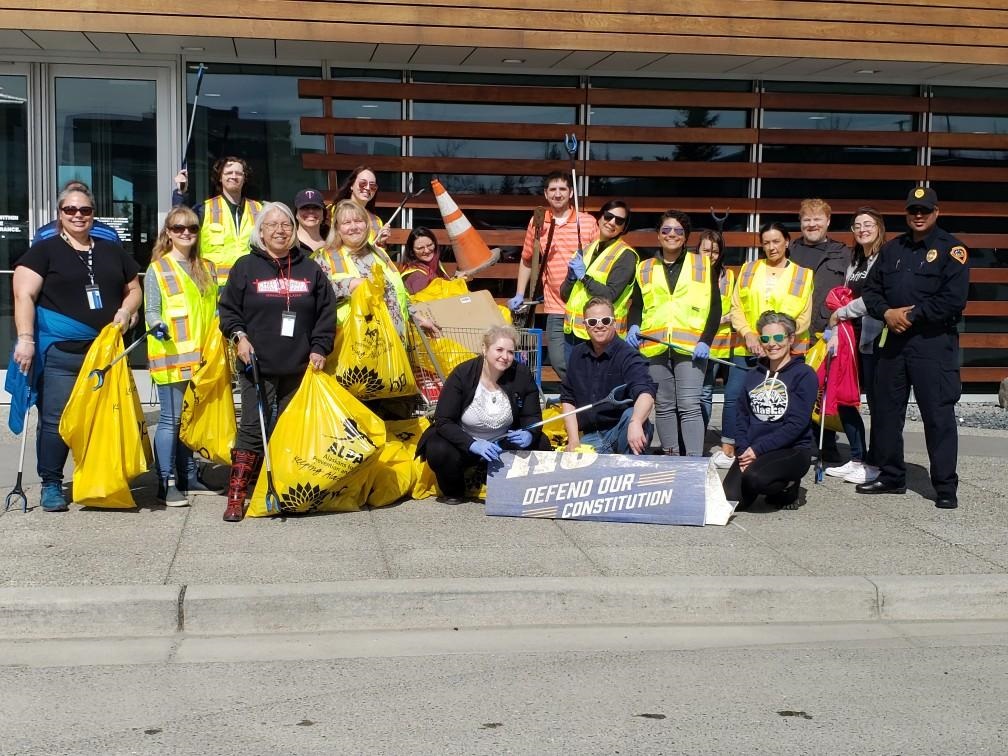 Group of Umialik employees posing together during a community clean-up event.