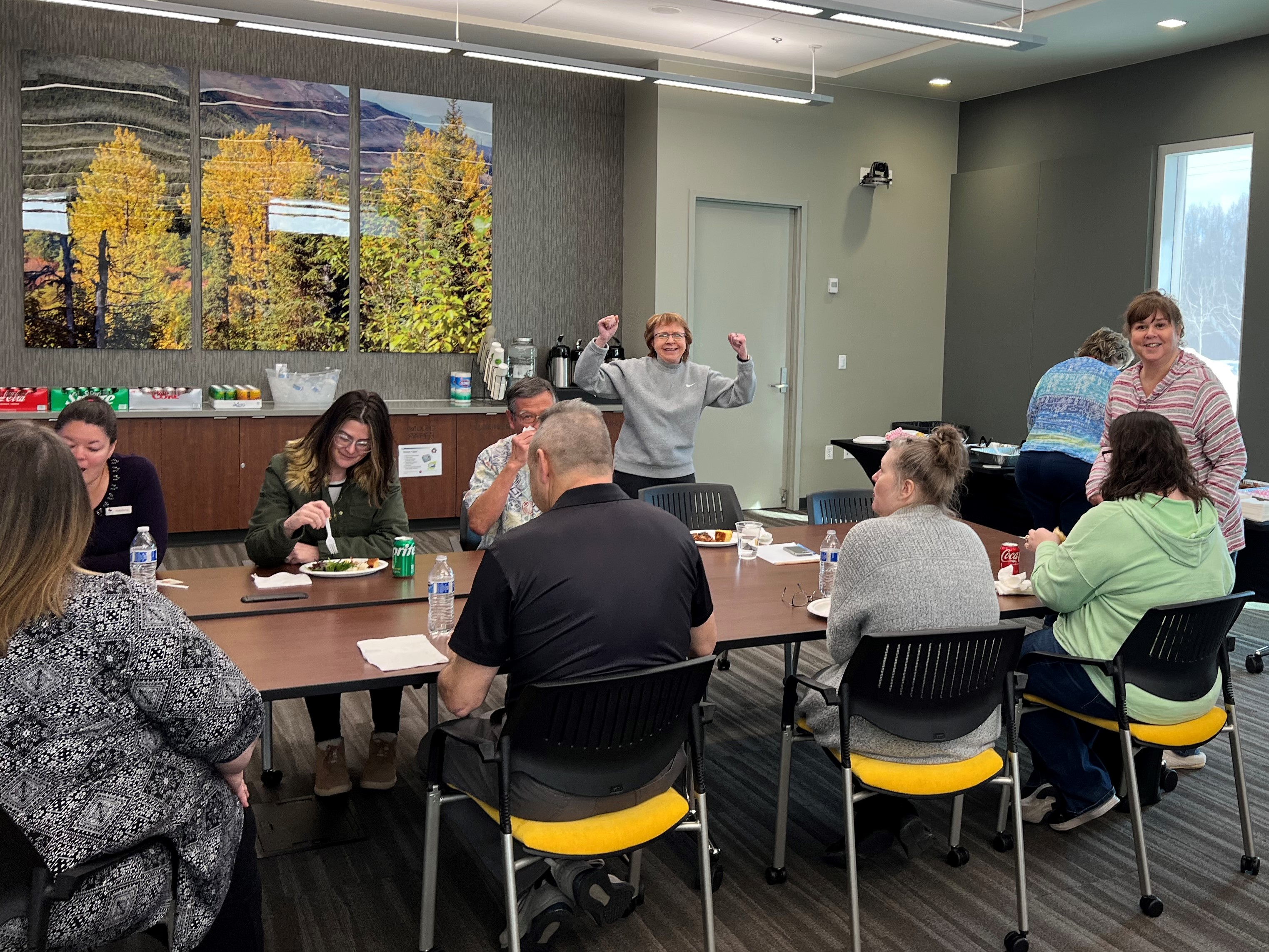 Umialik employees gathered in a conference room for a team lunch.